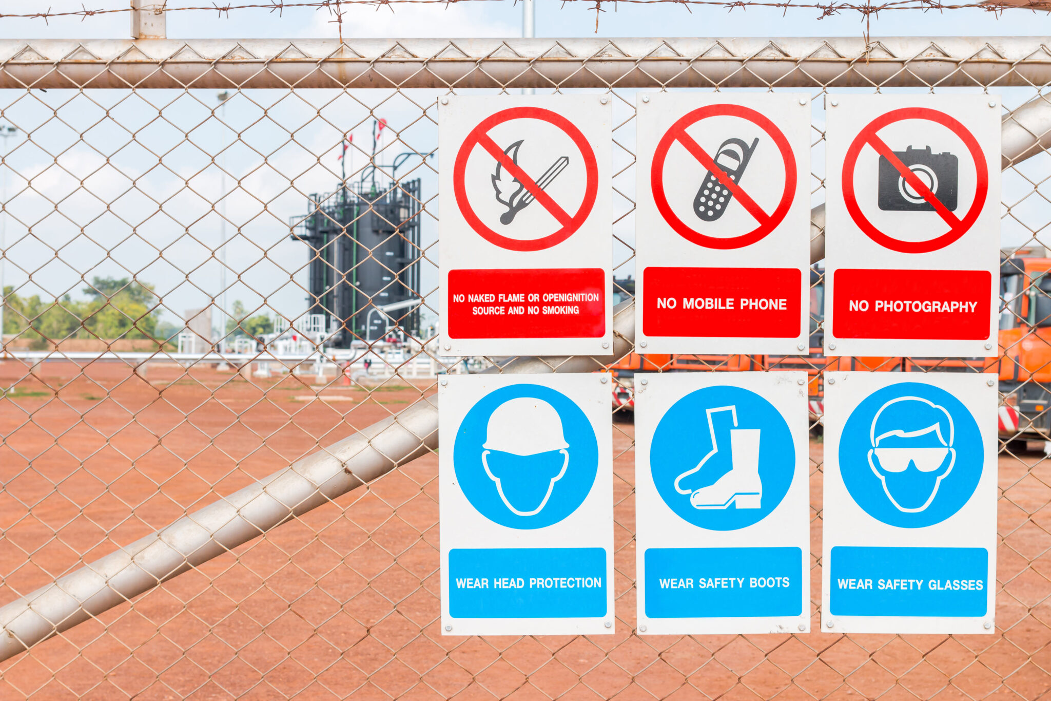 Safety signs placed on fence outside site