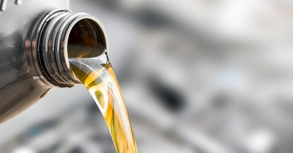 oil being poured into an industrial gearbox