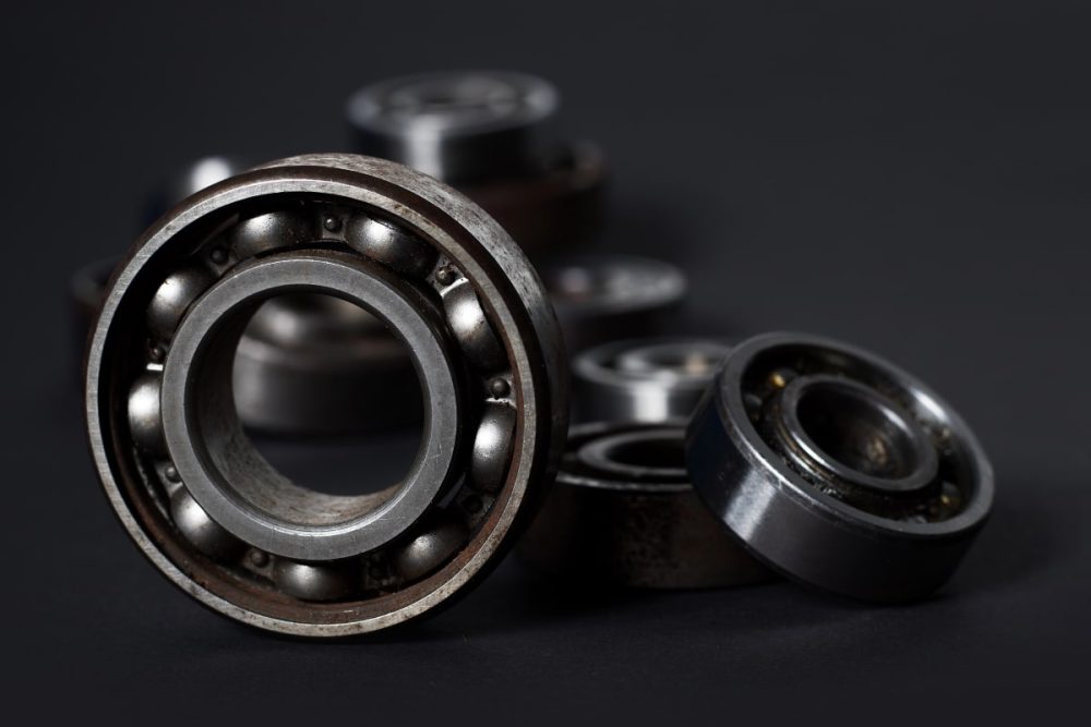 Close-up of radial ball bearings on a black background.