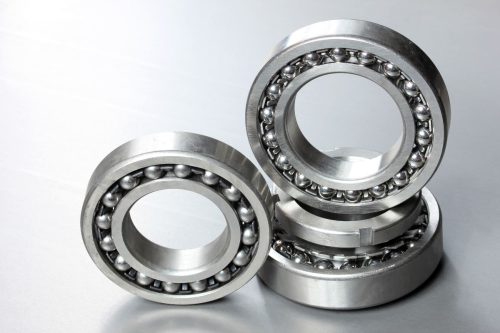 Mechanical ball bearings arranged on a table, relevant to the question what do the numbers on bearings mean and how to read them.